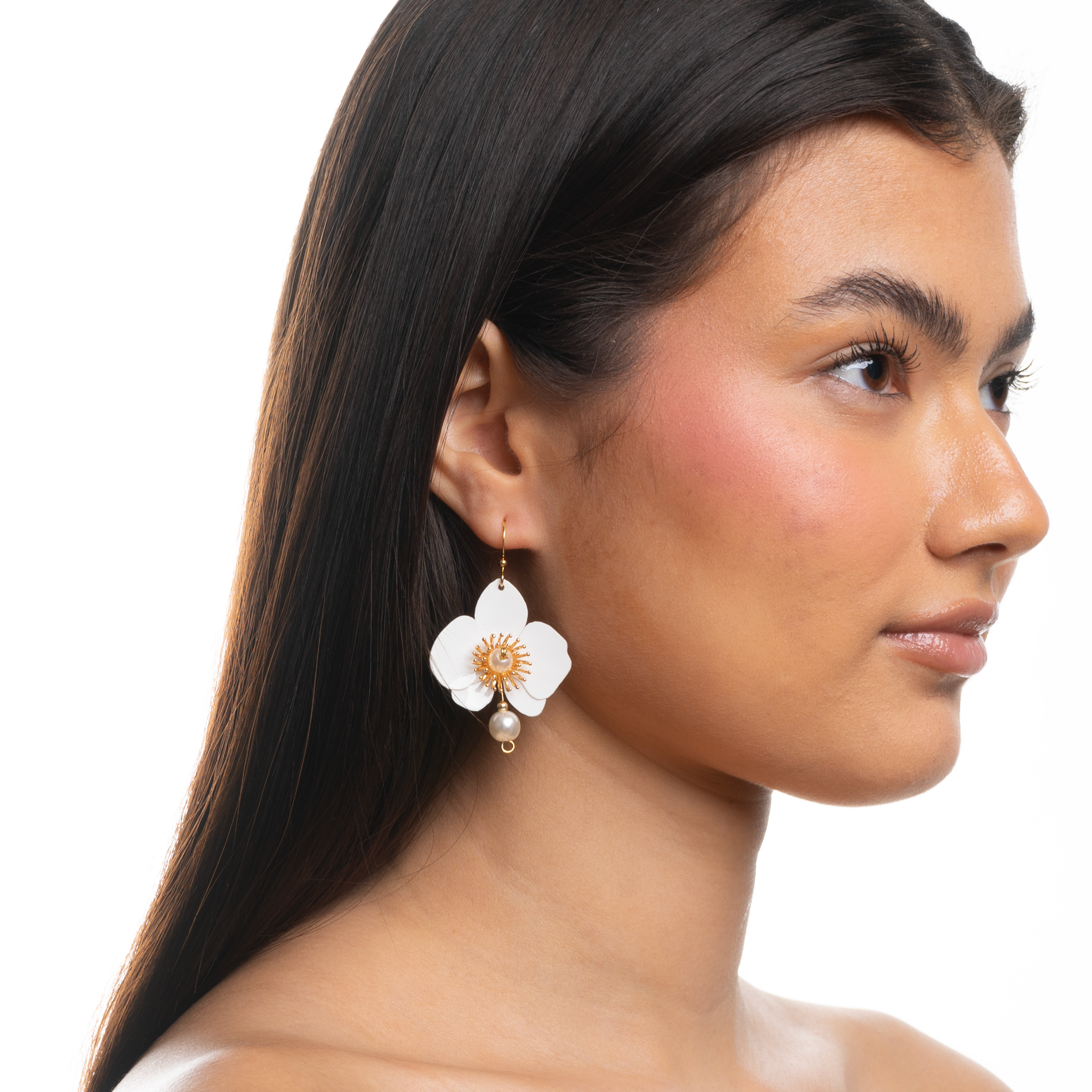 Woman wearing a floral earring on a white background
